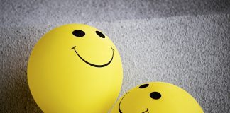 smiling faces on yellow balloons