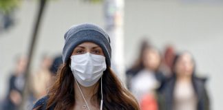 Woman wearing face mask on way to work