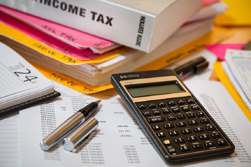 calculator and income tax book for payroll