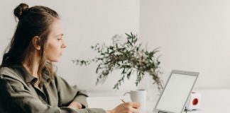 woman working from home sitting at laptop