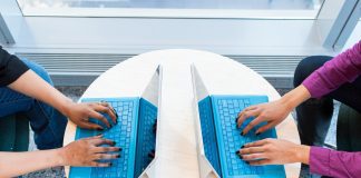 2 people working on laptops