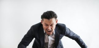 aggressive man stomping fist on desk