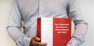 man holding The Protected Disclosures (Amendment) Bill 2022