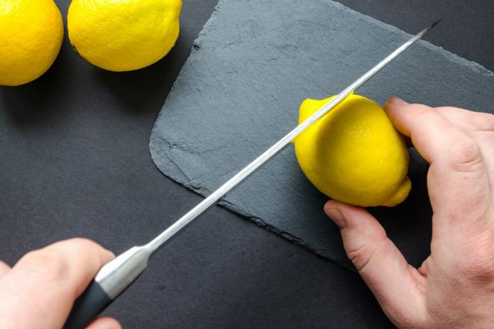 small part of lemon being cut off