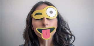 woman wearing happy face disguise