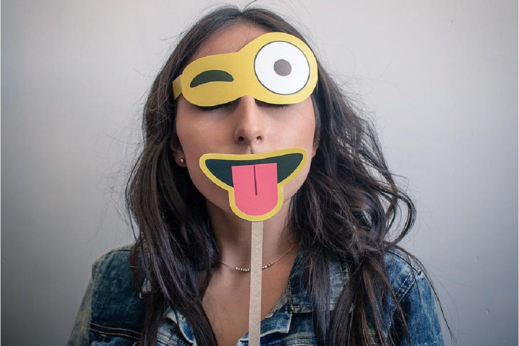 woman wearing happy face disguise