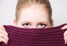 Woman hiding identity behind scarf