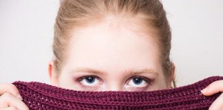 Woman hiding identity behind scarf