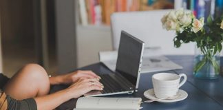 woman working from home at laptop on kitchen