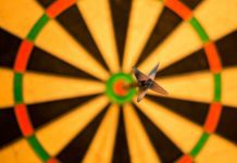 picture of dart in bullseye against blurred out dartboard