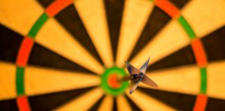 picture of dart in bullseye against blurred out dartboard