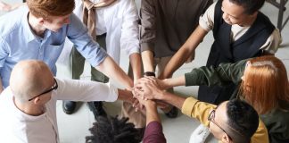 diverse team huddling together