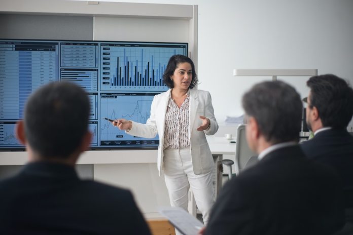 Woman Presenting at a screen in the Office