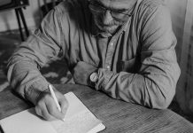 Man Writing in notebook