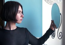 woman looking into mirrorr
