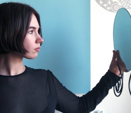 woman looking into mirrorr